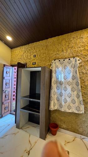 a room with a cabinet with a television and a pillow at Vistara Beach Resort Malpe - Udupi in Udiyāvara