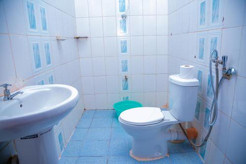 a bathroom with a toilet and a sink at Malava-K-Resort in Kakamega