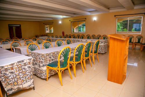 a group of tables and chairs in a room at Malava-K-Resort in Kakamega