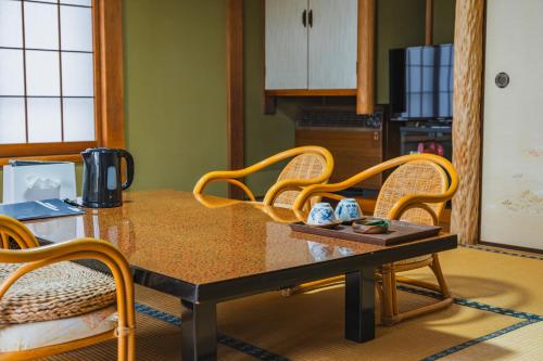 a kitchen with a table with chairs at HOTEL LT Kitchen Yugawara in Yugawara