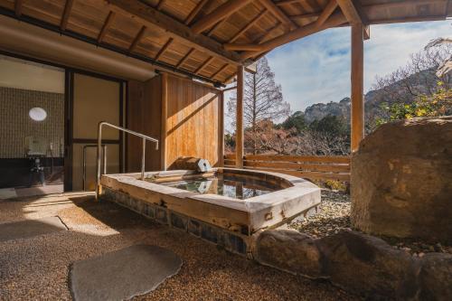 a large stone tub sitting inside of a building at HOTEL LT Kitchen Yugawara in Yugawara