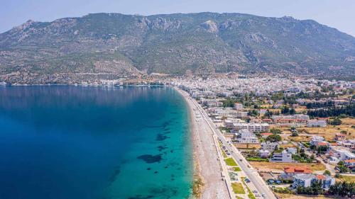 an aerial view of a beach with a city and mountains at Loutraki Getaway - Cozy and Quiet Nest in Loutraki