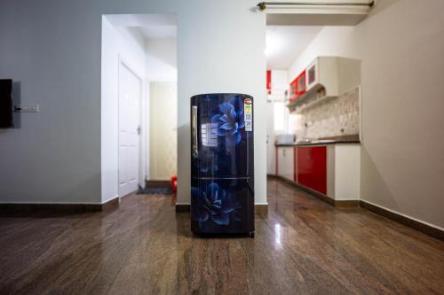 a refrigerator with blue flowers on it in a room at HRBR Enclave one BHK with fully furnished in Bengaluru