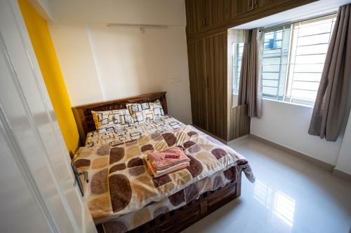 a bedroom with a bed in a room with a window at HRBR Enclave one BHK with fully furnished in Bengaluru