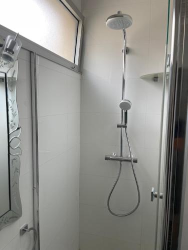 a shower in a bathroom with a shower head at Studio vue mer in Beaulieu-sur-Mer
