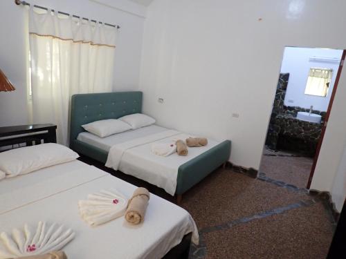 a room with two beds and a mirror at White Chocolate Hills Resort in Zamboanguita