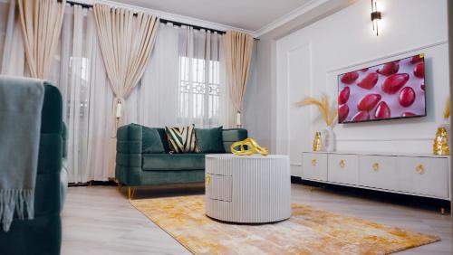 a living room with a couch and a table at Luxe City Stays by Daph in Buwate