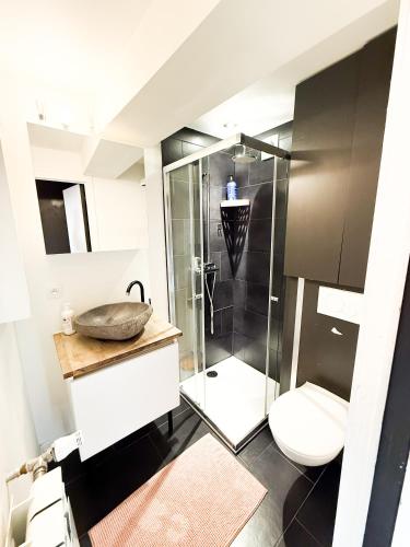 a bathroom with a shower with a toilet and a sink at NAMMOS Home's in Antwerp