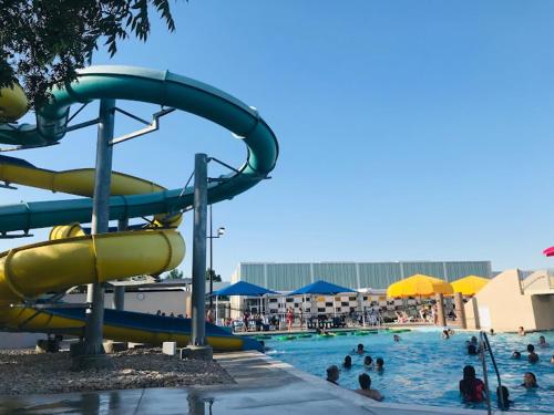 a group of people in a pool at a water park at Charming 3-bedroom house near AT&T Stadium, Six Flag, DFW Airport in Bedford