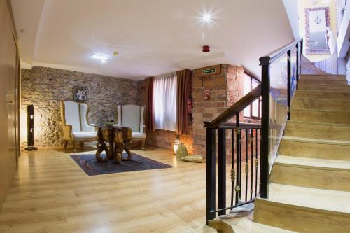 a living room with a staircase and a brick wall at Don Pedro in Avilés