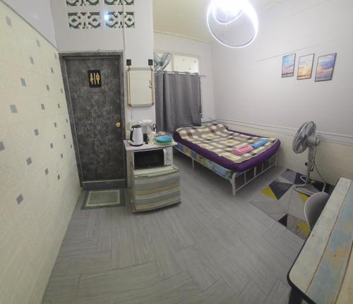 a hospital room with a bed and a table at 103 Olan Place Apartment with fan and near SkyTrain and free Wi-Fi in Bangkok