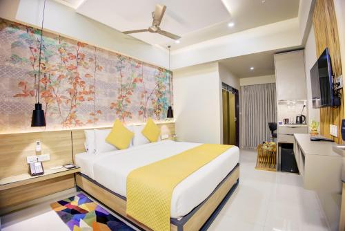 a hotel room with a bed and a desk at Cozzet Mahad in Mahad