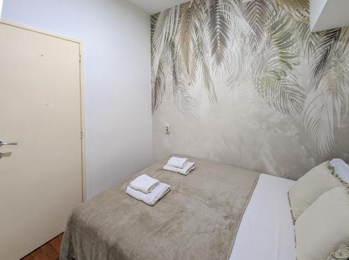 a bedroom with a bed with two towels on it at Central Peaceful Nest Belgrade in Belgrade