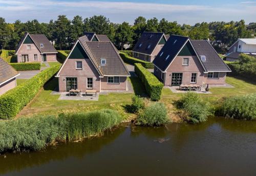 an aerial view of a row of houses next to a river at Beach Resort Makkum in Makkum