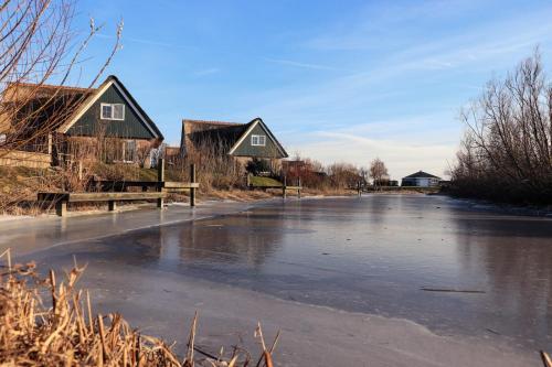 a frozen road with houses and houses on it at Beach Resort Makkum in Makkum