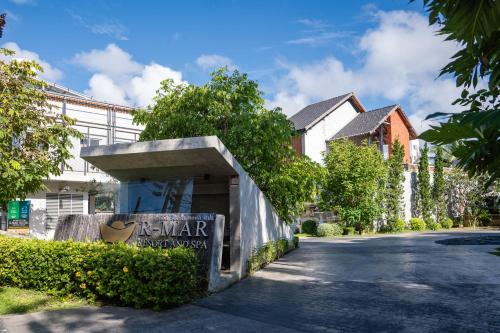 a building with a sign on the side of a road at R-Mar Resort and Spa Patong, Phuket in Patong Beach