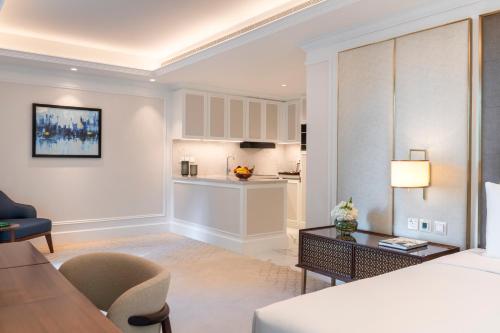 a living room with a couch and a table at Cheval Maison - Expo City Dubai in Dubai