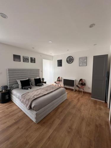 a large bedroom with a large bed and wooden floors at GuestReady - Amazing Studio near Disneyland in Montévrain