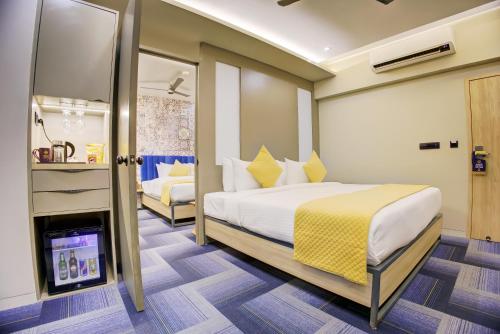 a hotel room with a bed and a bathroom at Cozzet Mahad in Mahad