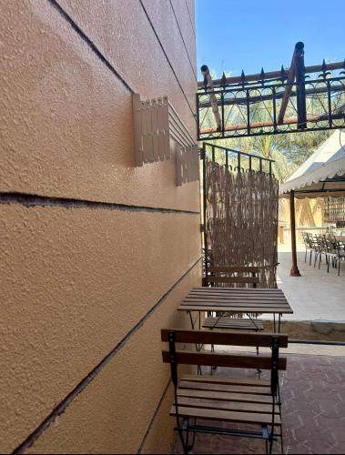 a couple of benches sitting next to a building at Al Ain Hotel Apartment Family Stay with Balcony and Pool Access in Al Ain