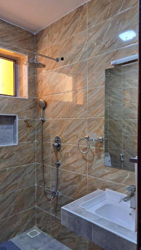a bathroom with a sink and a shower at Casa Marabella in Diani Beach
