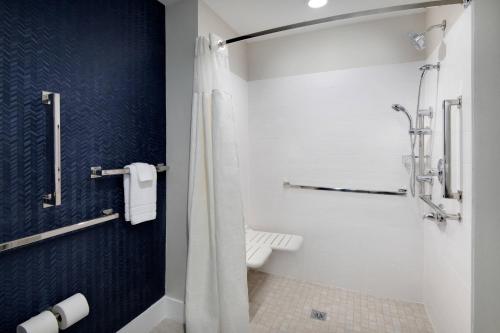 a bathroom with a shower and a toilet at Fairfield Inn & Suites Columbia Downtown in Columbia
