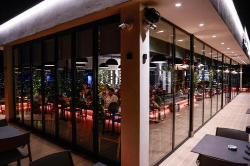a restaurant with a view of the city at night at Class rooms Tirana in Tirana