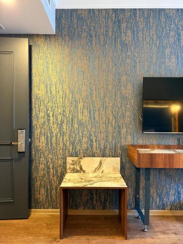 a bench in a room with a wall with wallpaper at The Yalı Konak Hotel İzmir in Izmir
