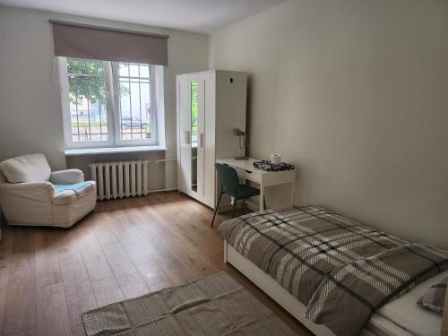 a bedroom with a bed and a desk and a chair at Peaceful Room in Shared Flat Close to Old Town in Tallinn