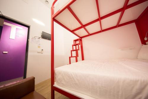 a bedroom with a bunk bed with a ladder at SleepBox Hostel in Taipei