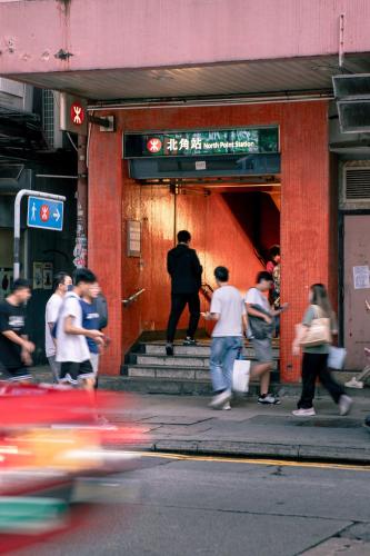 a group of people walking outside of a building at ibis Hong Kong North Point in Hong Kong