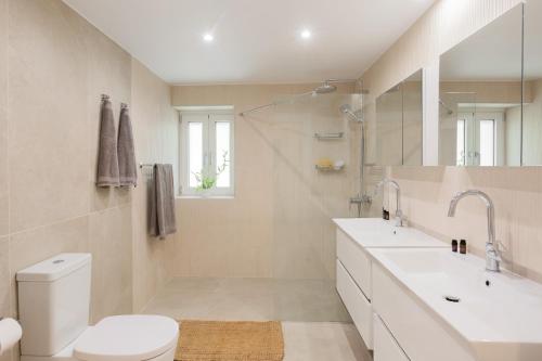 a bathroom with a toilet and a sink and a shower at Spacious House with Cottage&Pool in Nafplio
