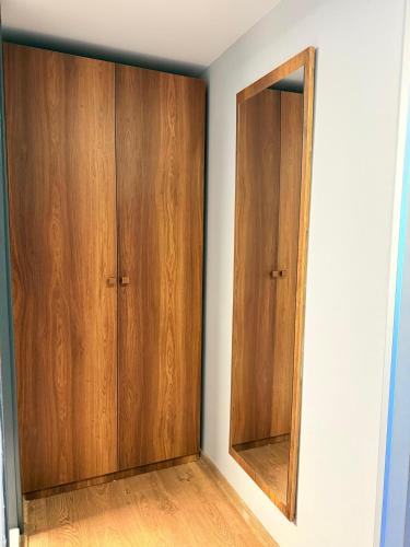 a room with two wooden cabinets and a mirror at The Yalı Konak Hotel İzmir in Izmir