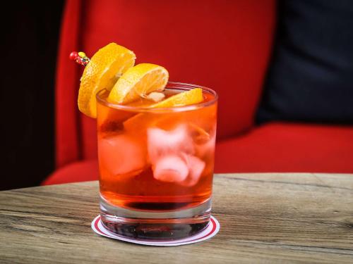 a drink with orange slices on a table at Ibis Sfax in Sfax