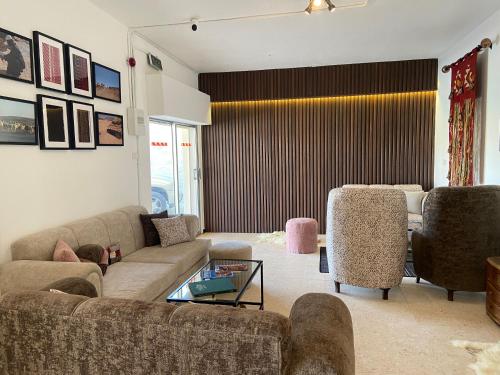 a living room with a couch and two chairs at Baytna Hotel in Petra