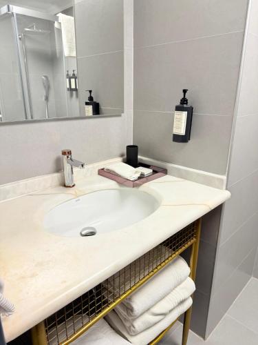 a bathroom with a sink and a mirror at The Yalı Konak Hotel İzmir in Izmir