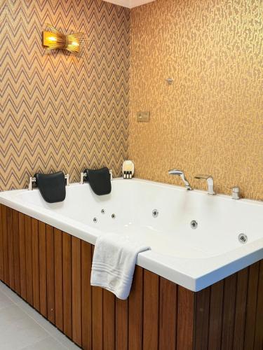 a bathroom with a large white bath tub at The Yalı Konak Hotel İzmir in Izmir