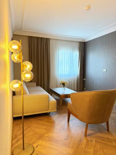 a living room with a couch and a table at The Yalı Konak Hotel İzmir in Izmir
