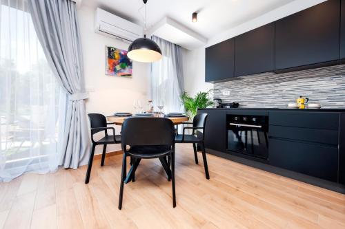 a kitchen and dining room with a table and chairs at Apartments with private jacuzzi Garbin 1 and Garbin 2 in Rovinj
