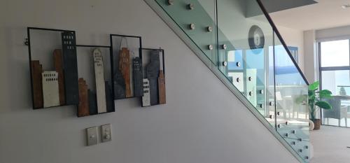 a wall with pictures of buildings on it at Villa 3 Luxe Coastal Escape in Cable Bay