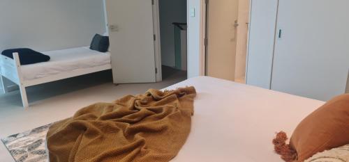 a blanket laying on a bed in a room at Villa 3 Luxe Coastal Escape in Cable Bay