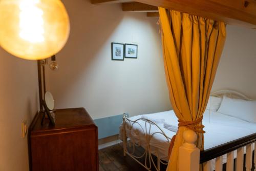 a bedroom with a bed with a yellow curtain at Número 8 a Traditional Basque Village Homestead in Laguardia