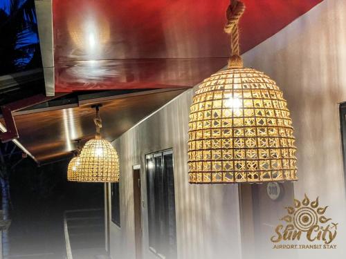 two lights hanging from the ceiling in a room at SunCity Airport Transit Stay in Minuwangoda