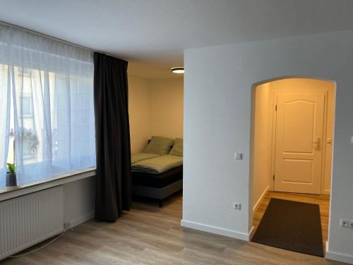 a small bedroom with a bed and a window at Ferienwohnung Ruhr in Mülheim an der Ruhr