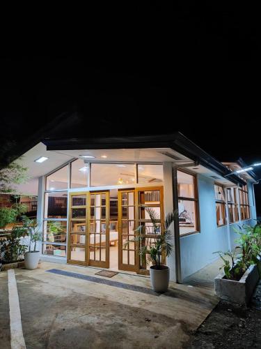 a small building with glass doors and potted plants at DMC Condotel in Puerto Princesa City