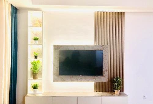 a living room with a television on a wall at Monaara Lesuire Colombo 3 in Colombo