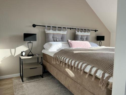 a bedroom with a large bed with white pillows at Ostsee-AuszeitDahme in Dahme