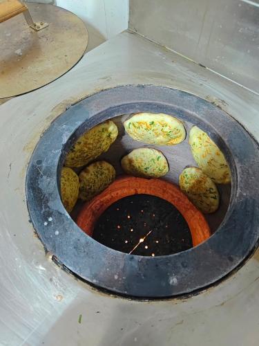a pot filled with lots of vegetables on the ground at Lamahatta Clouds Hotel & Restaurant in Takdāh
