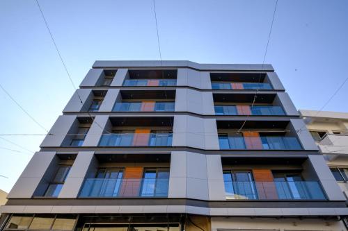 a tall apartment building with colorful windows at Maestro City Apartments in Larnaca