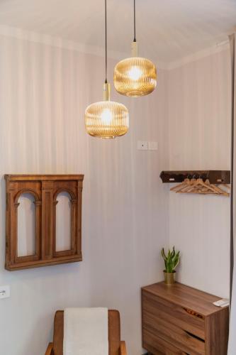 a room with three lights and a bed and a table at Affittacamere Zanobi 45 in Florence